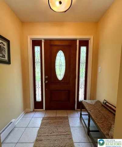 a view of a hallway with entryway door
