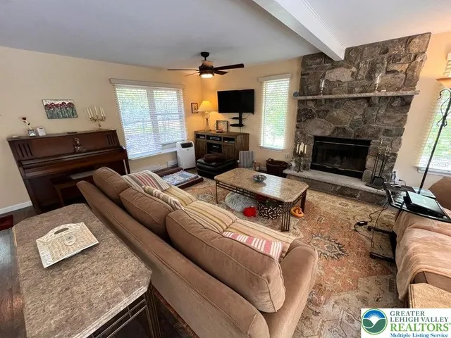 a living room with furniture and a fireplace