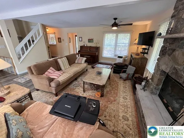 a living room with furniture and a fireplace