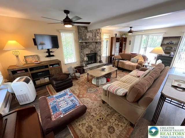 a living room with furniture and a fireplace