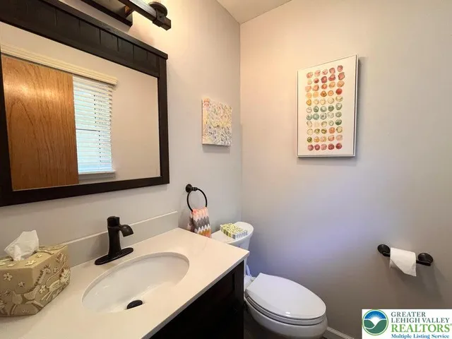 a bathroom with a sink a toilet and mirror