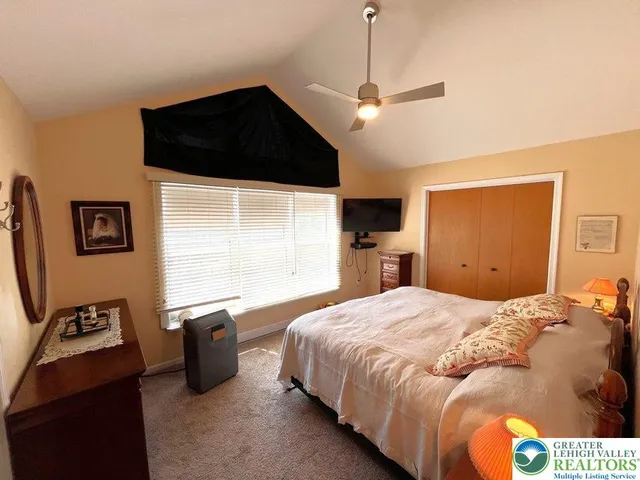 a bedroom with a bed and a television