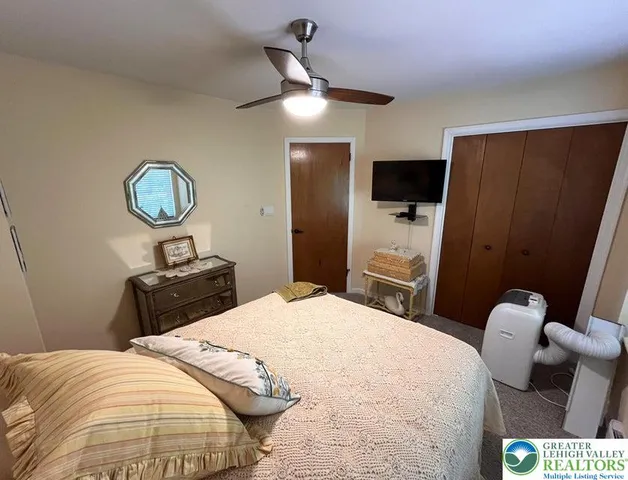 a bedroom with a bed and a mirror