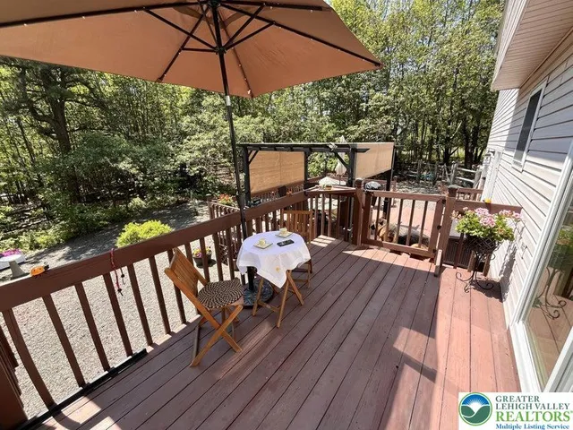 a view of balcony with furniture and wooden floor