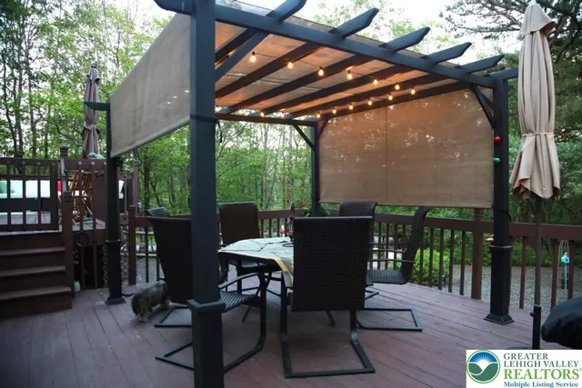 a view of a porch with furniture and a yard