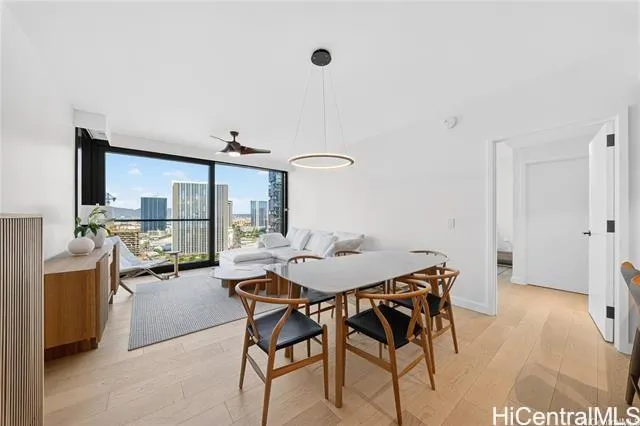 a view of a dining room with furniture and a large window
