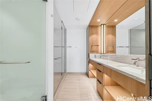 a spacious bathroom with a granite countertop sink and a mirror