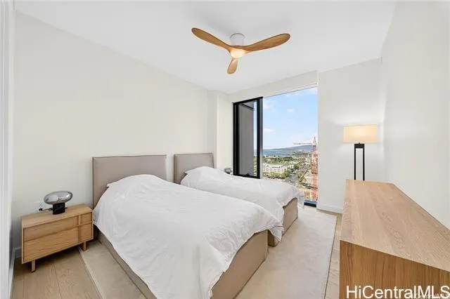 a bedroom with a bed and a large window