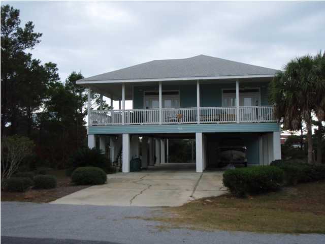 Lot 4 Maple Street Santa Rosa Beach, FL 32459 - Photo 4 of 15 a front view of a house with plants and trees