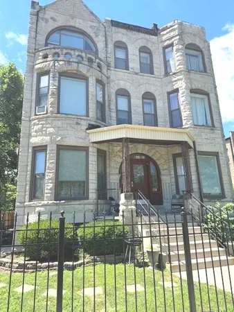 a view of a brick house with a swimming pool