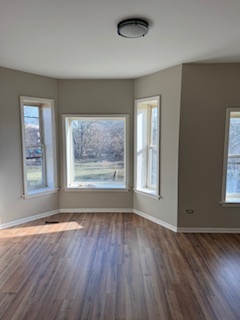 6418-20 South Stewart Avenue Chicago, IL 60621 - Photo 12 of 41 a view of an empty room with wooden floor and a window