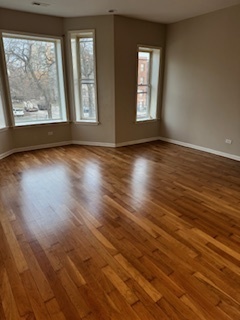 6418-20 South Stewart Avenue Chicago, IL 60621 - Photo 14 of 41 a view of an empty room with wooden floor and a window