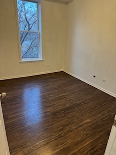 6418-20 South Stewart Avenue Chicago, IL 60621 - Photo 15 of 41 a view of an empty room with wooden floor