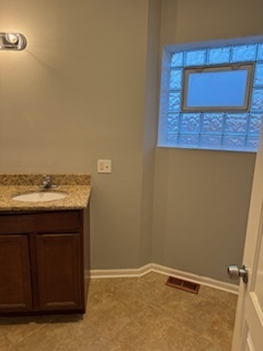 6418-20 South Stewart Avenue Chicago, IL 60621 - Photo 18 of 41 a bathroom with a sink and a mirror