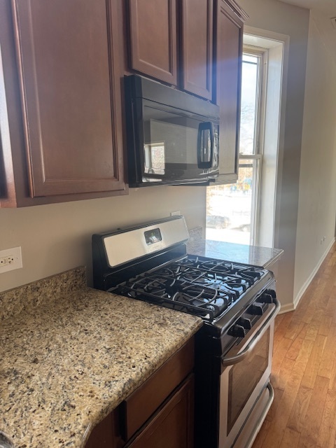 6418-20 South Stewart Avenue Chicago, IL 60621 - Photo 26 of 41 a kitchen with stainless steel appliances granite countertop a stove a sink and a microwave