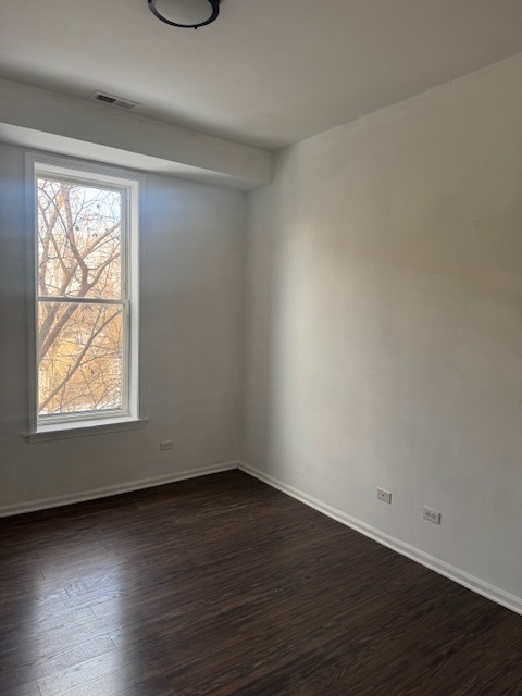6418-20 South Stewart Avenue Chicago, IL 60621 - Photo 29 of 41 an empty room with wooden floor and windows