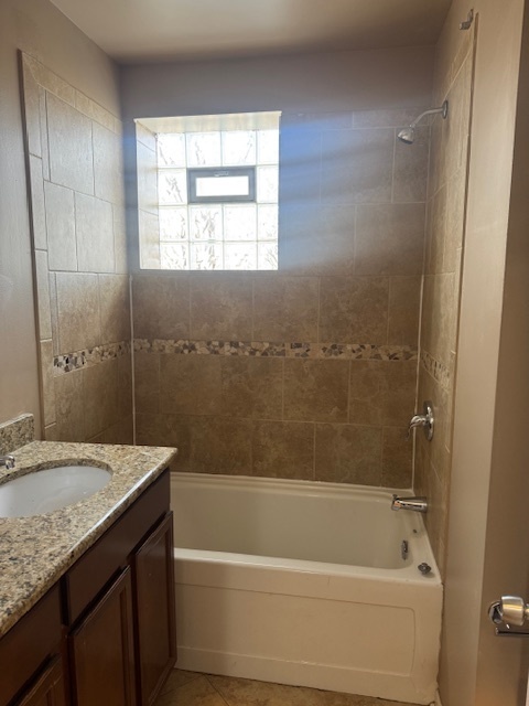6418-20 South Stewart Avenue Chicago, IL 60621 - Photo 31 of 41 a bathroom with a granite countertop sink a mirror bathtub and shower