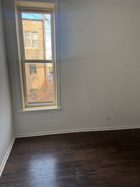 6418-20 South Stewart Avenue Chicago, IL 60621 - Photo 35 of 41 a view of an empty room with wooden floor and a window