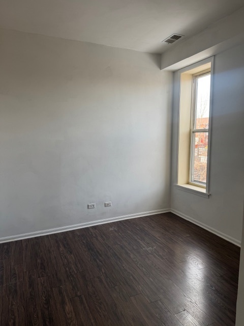 6418-20 South Stewart Avenue Chicago, IL 60621 - Photo 37 of 41 an empty room with wooden floor and windows