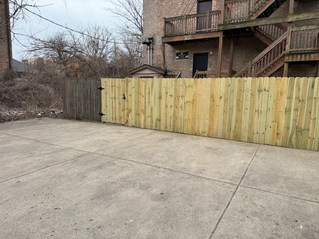 6418-20 South Stewart Avenue Chicago, IL 60621 - Photo 40 of 41 a view of a house with a wooden fence