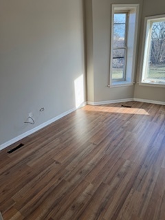 6418-20 South Stewart Avenue Chicago, IL 60621 - Photo 8 of 41 an empty room with wooden floor and windows