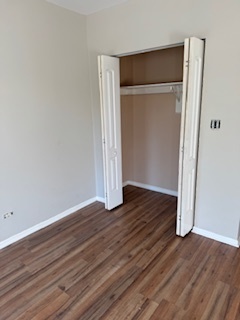 6418-20 South Stewart Avenue Chicago, IL 60621 - Photo 10 of 41 a view of an empty room with wooden floor and closet
