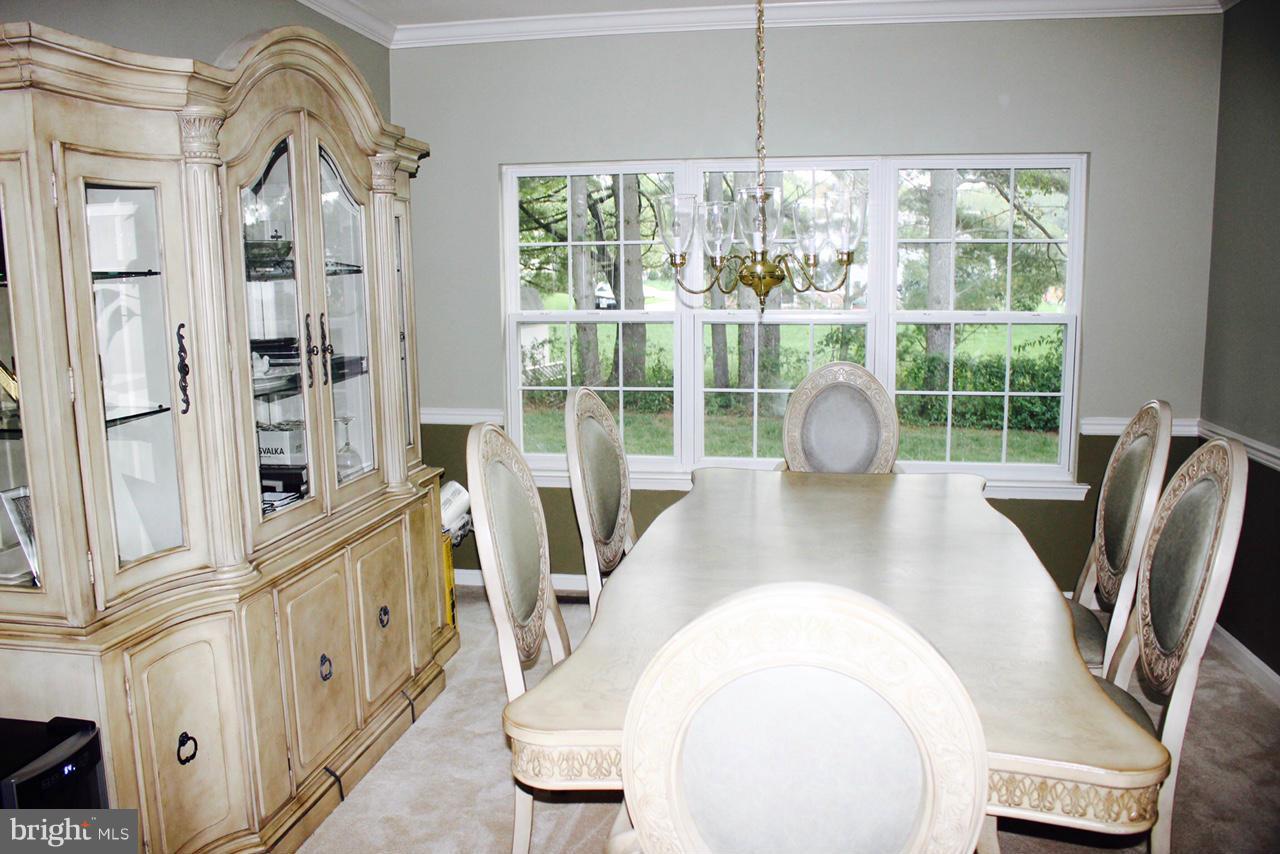 1322 North Rolling Road Baltimore, MD 21228 - Photo 15 of 30 a view of a dining room with furniture window and wooden floor
