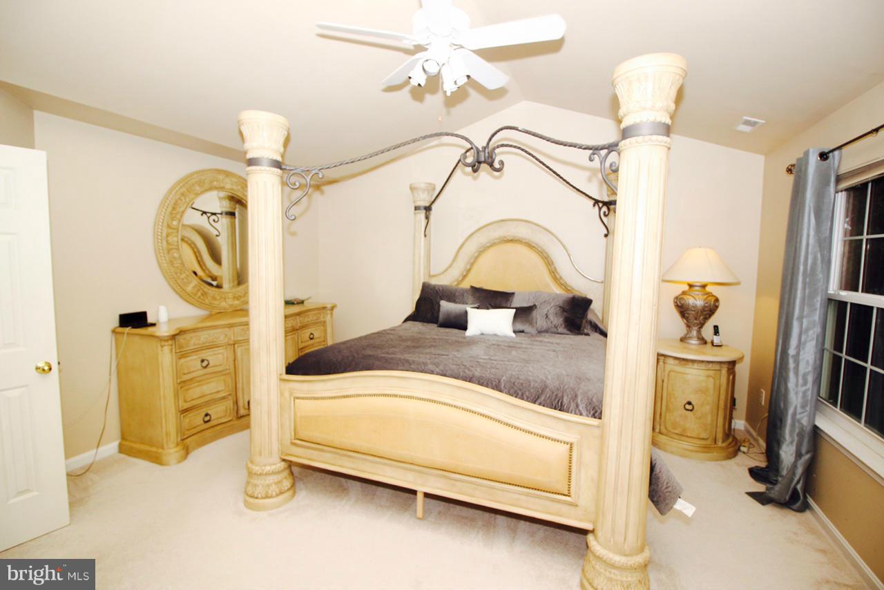 1322 North Rolling Road Baltimore, MD 21228 - Photo 21 of 30 a bedroom with a bed and a mirror