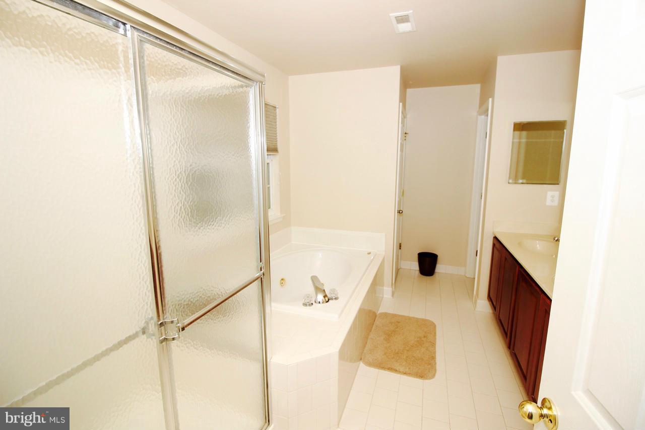 1322 North Rolling Road Baltimore, MD 21228 - Photo 24 of 30 a bathroom with a tub and shower