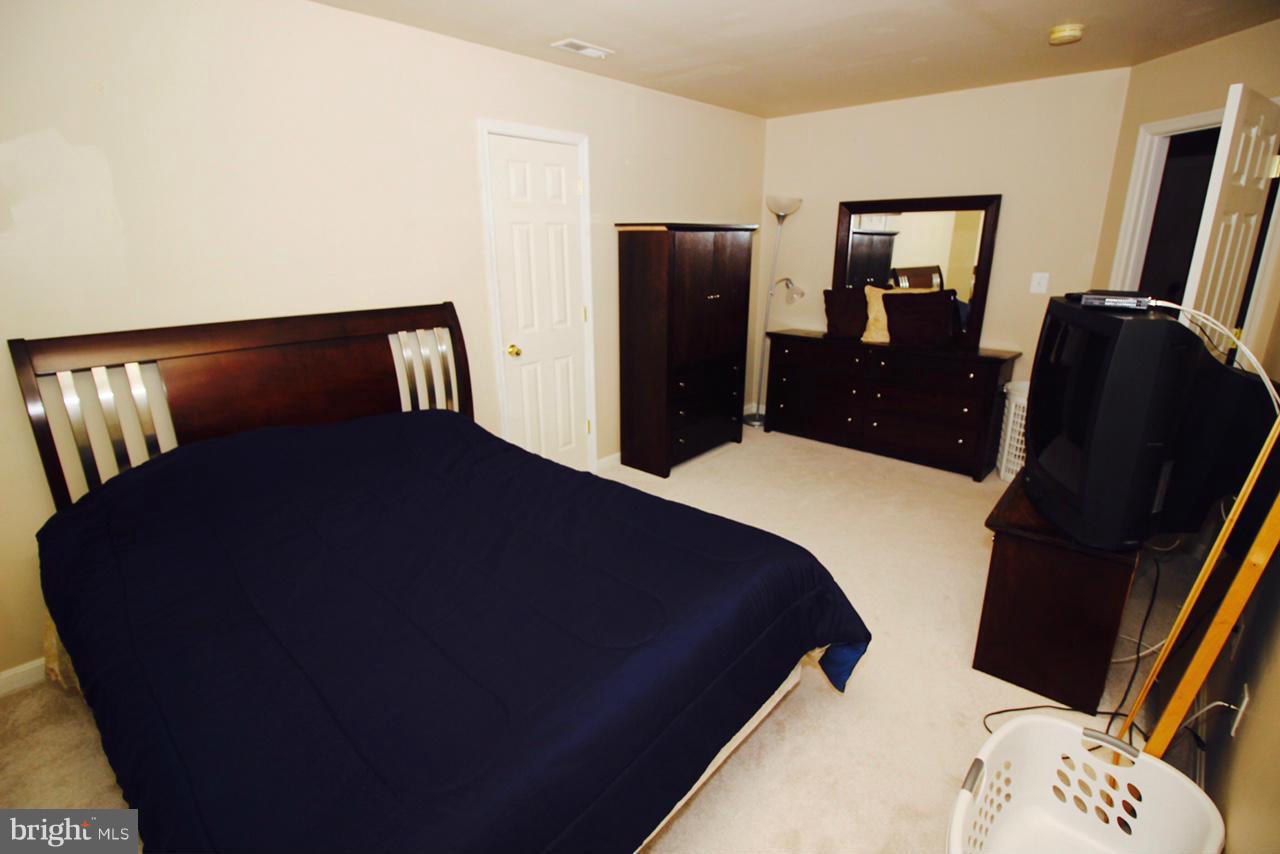 1322 North Rolling Road Baltimore, MD 21228 - Photo 28 of 30 a bed sitting in a bedroom next to a window