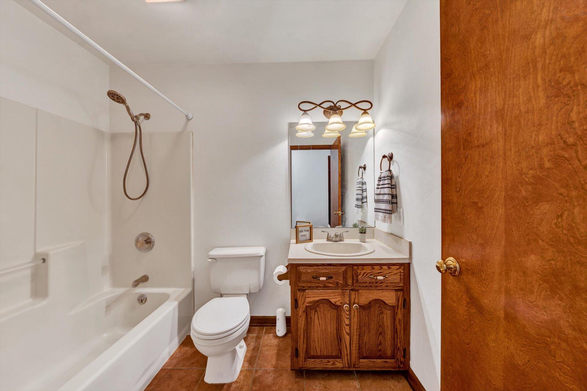 2921 Quarles Road Thaxton, VA 24174 - Photo 16 of 30 a bathroom with a granite countertop sink toilet and shower