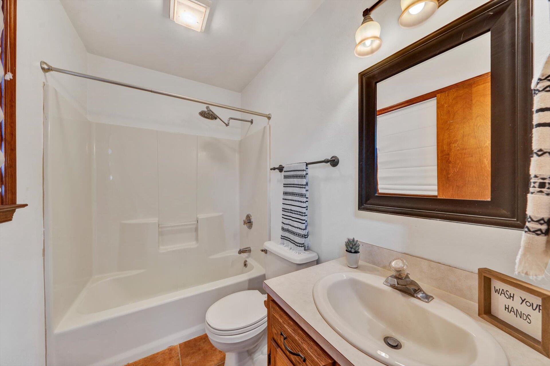 2921 Quarles Road Thaxton, VA 24174 - Photo 21 of 30 a bathroom with a sink toilet and shower