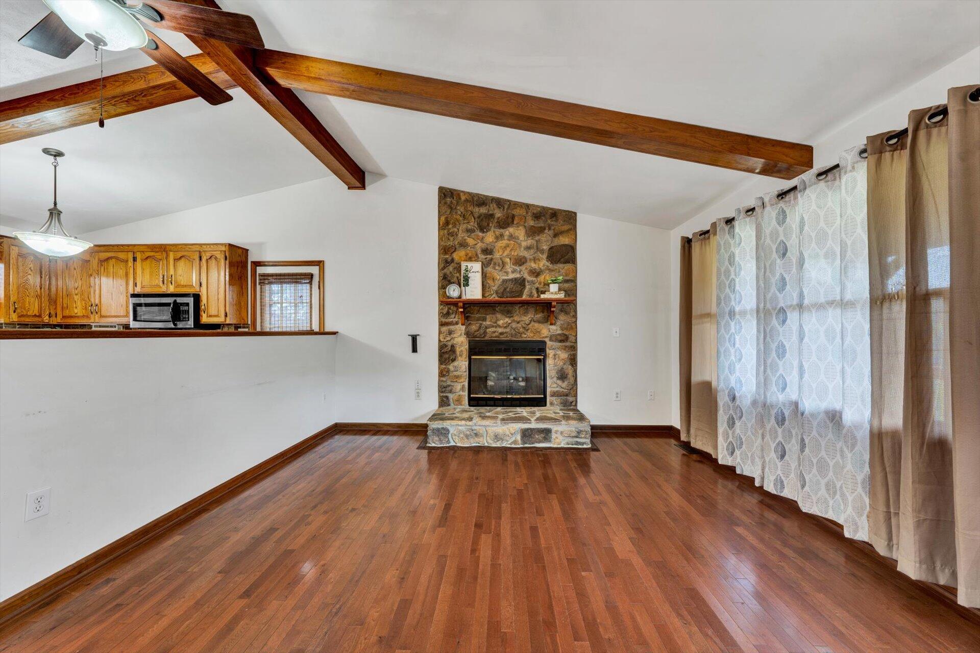 2921 Quarles Road Thaxton, VA 24174 - Photo 6 of 30 a view of a room with wooden floor staircase and a kitchen