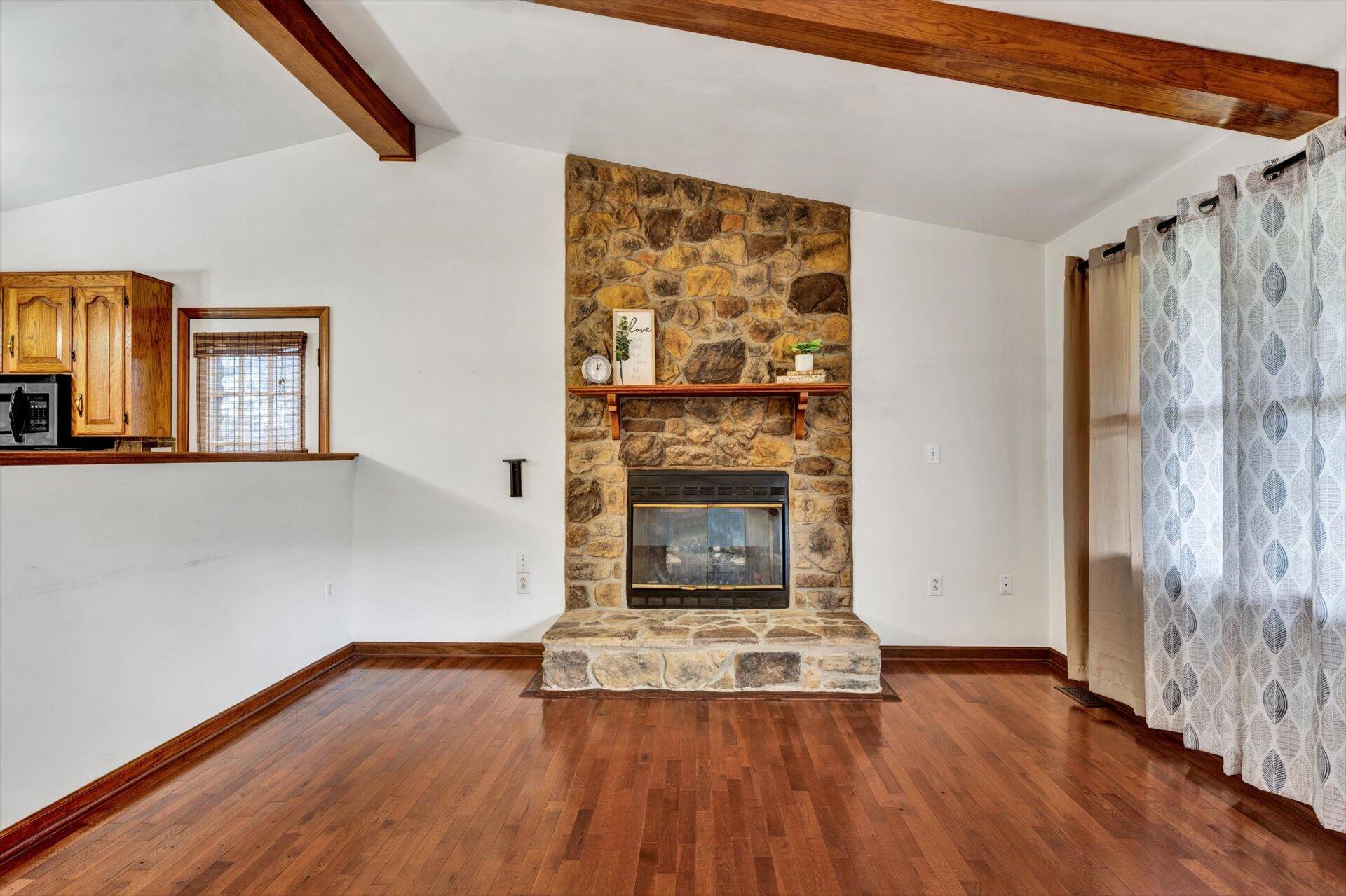 2921 Quarles Road Thaxton, VA 24174 - Photo 7 of 30 a view of a livingroom with wooden floor and a fireplace