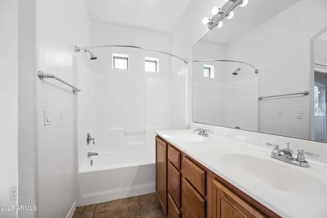 a bathroom with a sink a large mirror and shower
