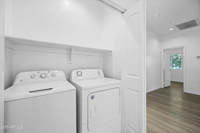 a view of storage and utility room with washer and dryer