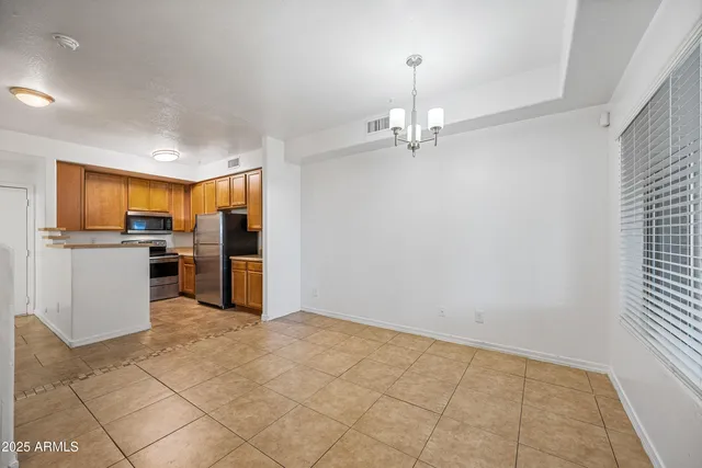 a view of a kitchen with a sink and refrigerator