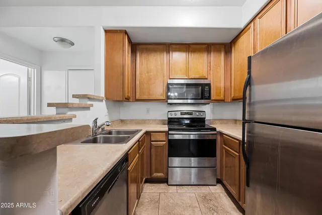 a kitchen with a sink stove and refrigerator
