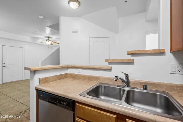 a kitchen with a sink and a refrigerator