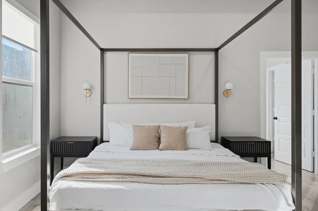 a bedroom with a large bed and a flat screen tv