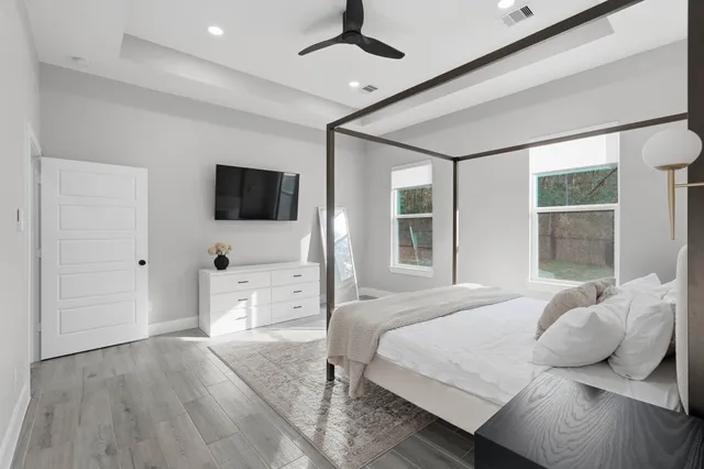 a spacious bathroom with a double vanity sink a toilet a bathtub and shower