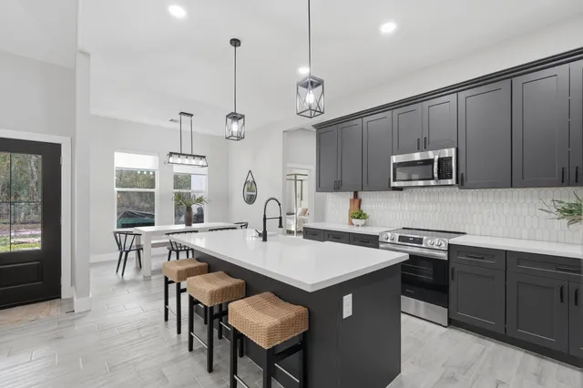 a kitchen with a sink center island and stainless steel appliances