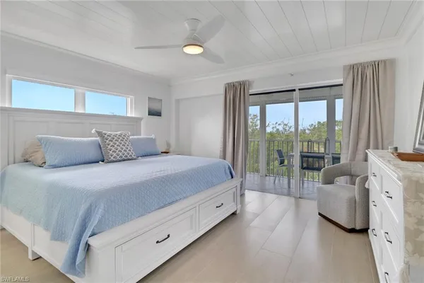 a bedroom with a bed and large window