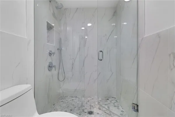 a bathroom with a shower and a toilet