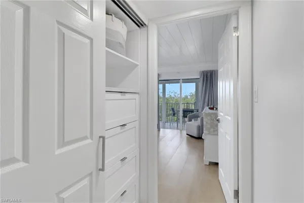 a view of a hallway with toilet and entryway