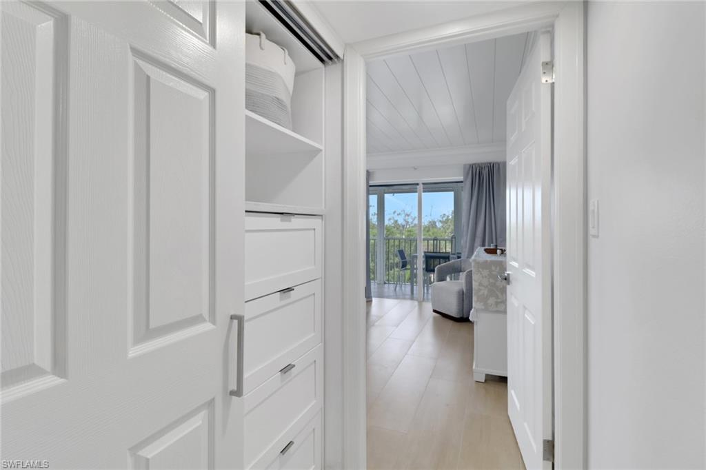 1 Bluebill Avenue, Unit 410 Naples, FL 34108 - Photo 15 of 36 a view of a hallway with toilet and entryway