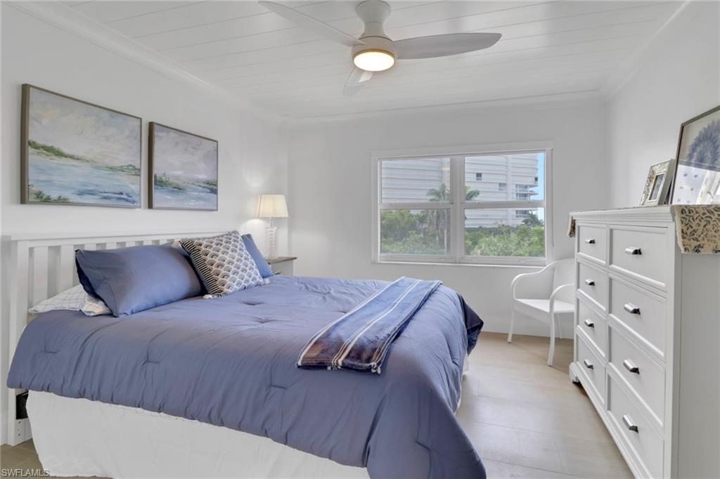 1 Bluebill Avenue, Unit 410 Naples, FL 34108 - Photo 16 of 36 a bedroom with a large bed and a window