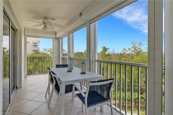a view of a balcony dining table and chairs