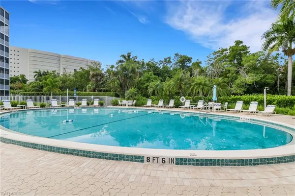 a view of a swimming pool with a yard