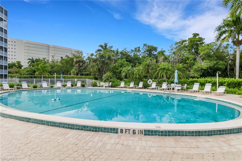 1 Bluebill Avenue, Unit 410 Naples, FL 34108 - Photo 23 of 36 a view of a swimming pool with a yard